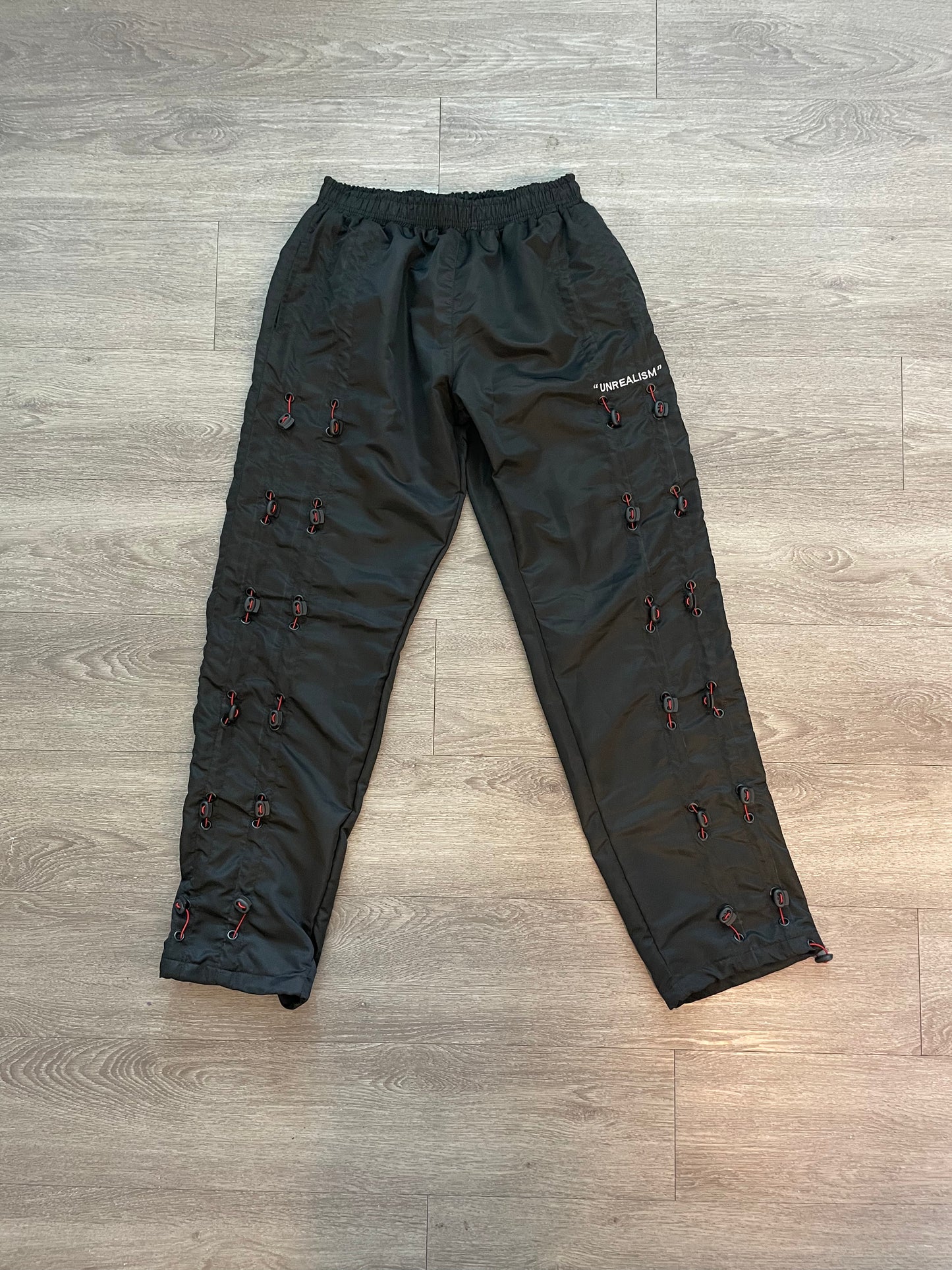 "UNREALISM" ZIP TIE GALORE PANTS (Unisex)